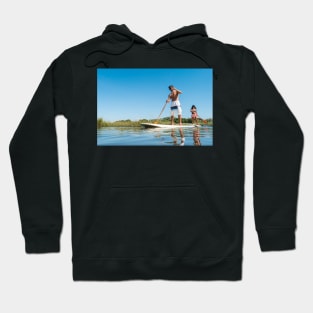 Man and woman stand up paddleboarding Hoodie